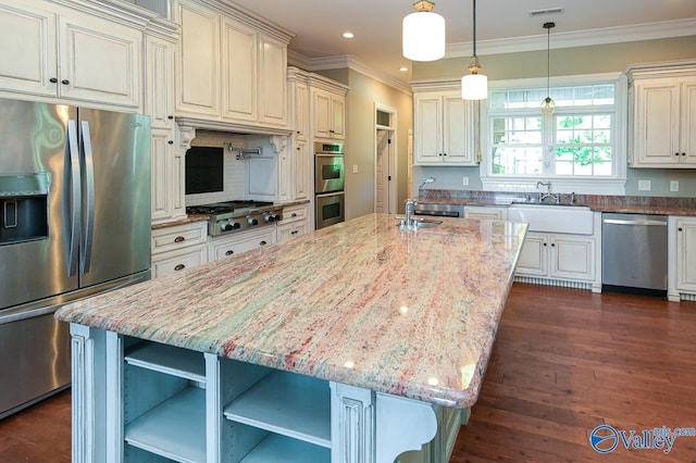 kitchen with dark wood-type flooring, sink, a kitchen island, stainless steel appliances, and light stone countertops