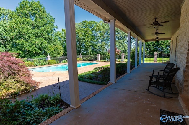 view of patio / terrace with ceiling fan and a fenced in pool