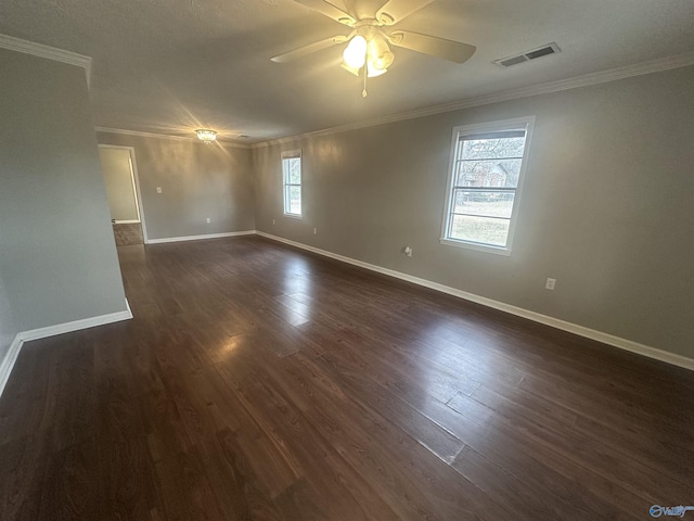 unfurnished room featuring dark wood-type flooring, ceiling fan, and crown molding