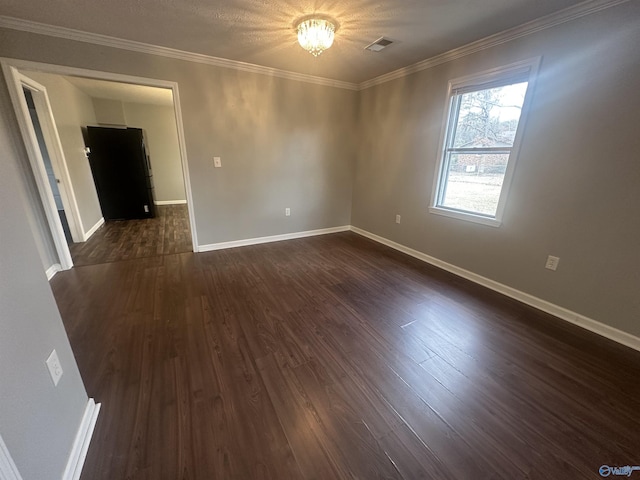 spare room with crown molding, dark hardwood / wood-style flooring, and an inviting chandelier