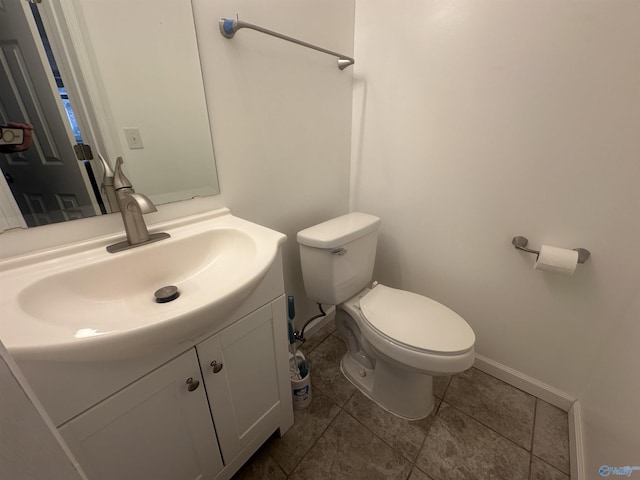 bathroom with tile patterned floors, vanity, and toilet