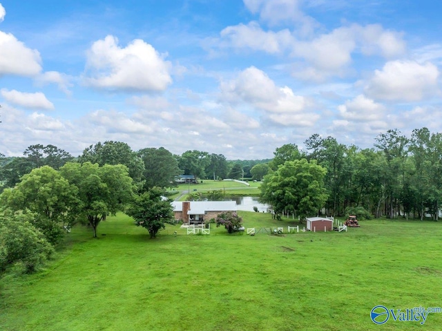 view of yard with a water view and an outbuilding