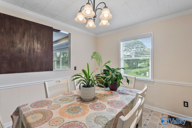 dining room with ornamental molding and an inviting chandelier