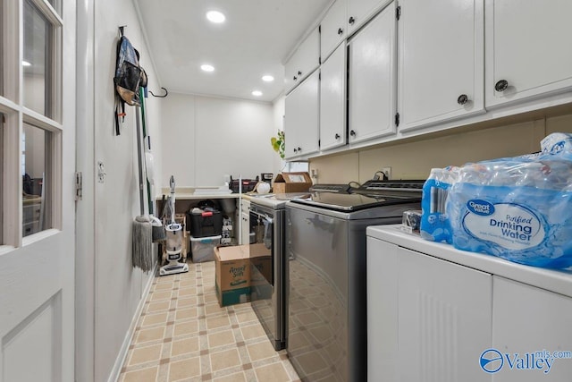 laundry room with cabinets and washing machine and dryer