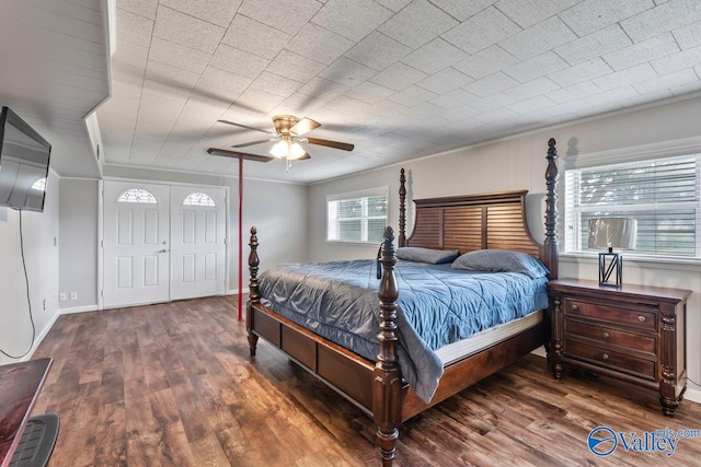 bedroom featuring ceiling fan, ornamental molding, and dark hardwood / wood-style flooring