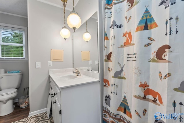 bathroom featuring hardwood / wood-style flooring, toilet, vanity, crown molding, and curtained shower