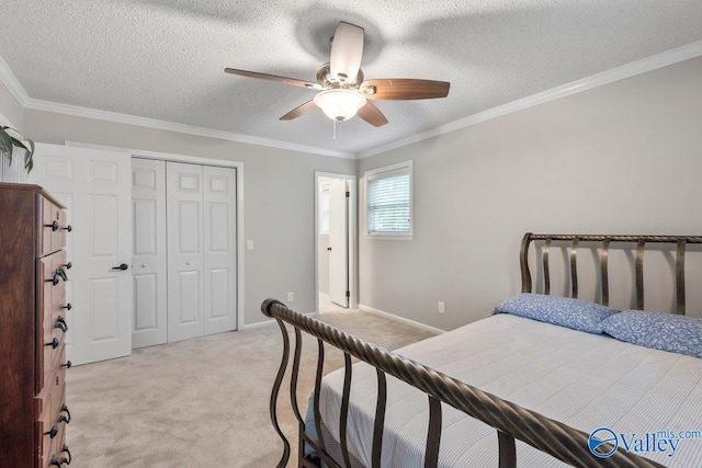 bedroom featuring a closet, crown molding, light colored carpet, a textured ceiling, and ceiling fan