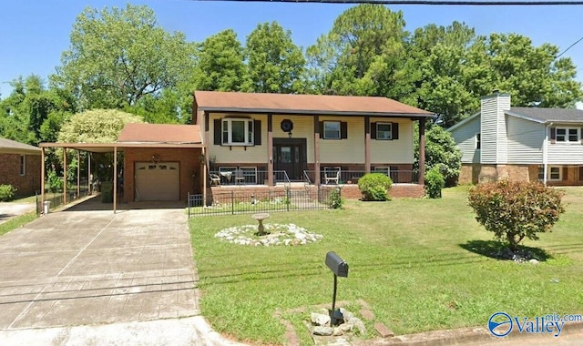 split foyer home with concrete driveway, an attached garage, a front yard, a carport, and brick siding