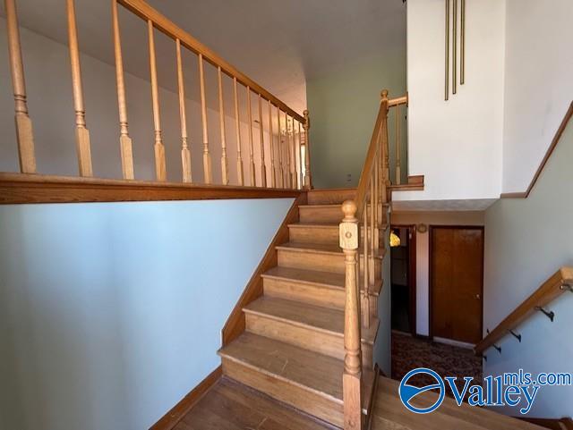 stairway featuring wood finished floors