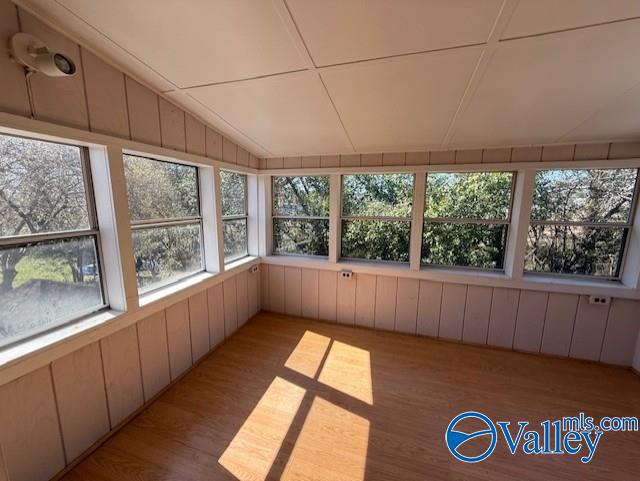 unfurnished sunroom with lofted ceiling