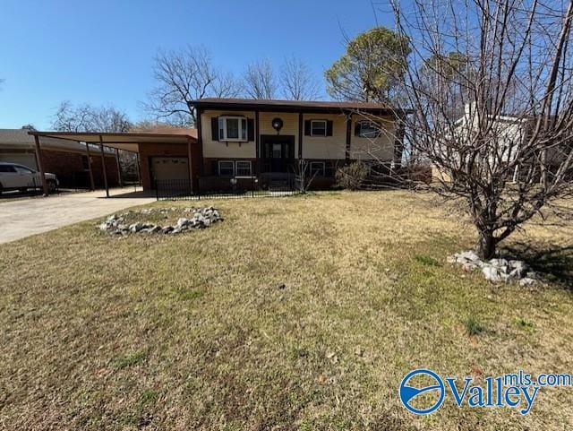 bi-level home featuring covered porch, a garage, driveway, a carport, and a front yard