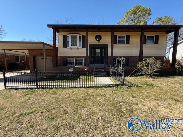 bi-level home with a fenced front yard, a garage, and a front lawn