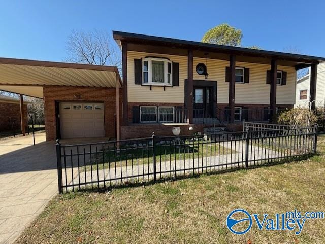 split foyer home featuring a garage, driveway, brick siding, and a fenced front yard