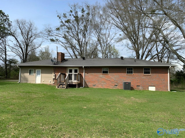 rear view of property with a wooden deck, a yard, and cooling unit