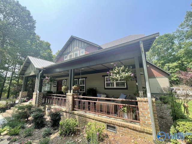 back of house featuring covered porch