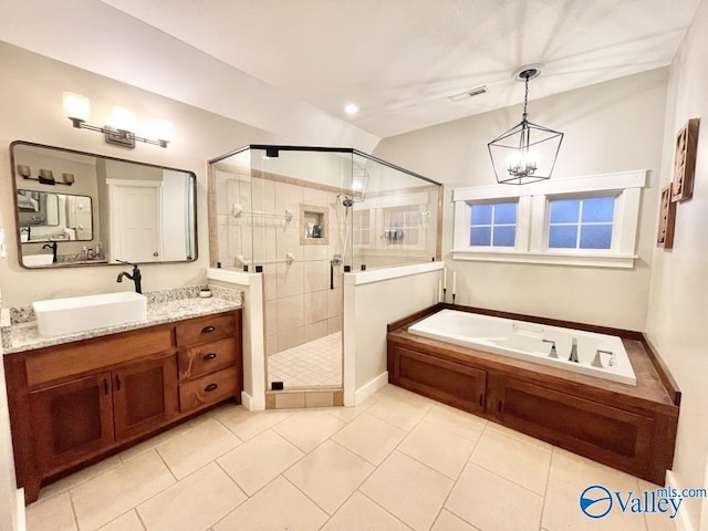 bathroom with vanity, tile patterned flooring, a chandelier, and shower with separate bathtub