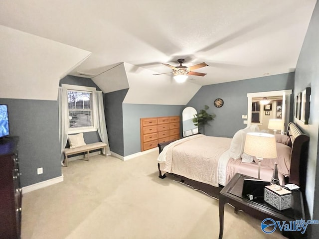 carpeted bedroom featuring ceiling fan and vaulted ceiling