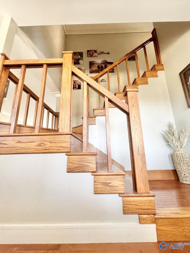 staircase featuring crown molding