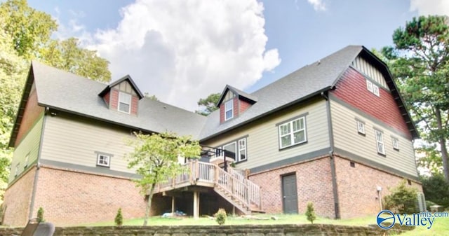 rear view of property featuring a wooden deck