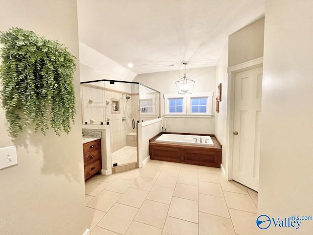 bathroom featuring tile patterned floors, shower with separate bathtub, vanity, and vaulted ceiling