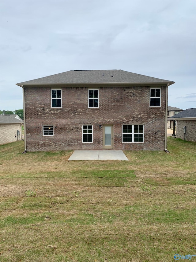 rear view of house with a yard and a patio area