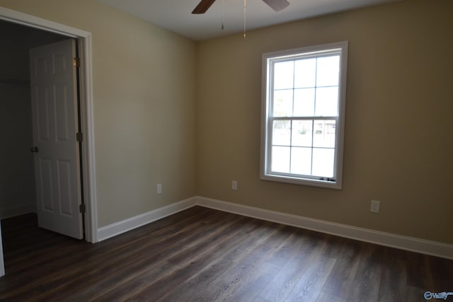 unfurnished room with dark wood-type flooring and ceiling fan