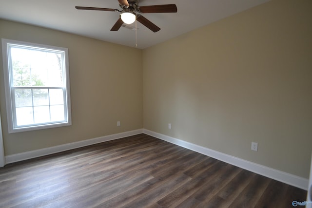 spare room with dark wood-type flooring and ceiling fan