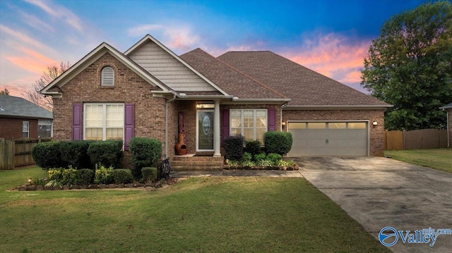 view of front of house with a garage and a lawn