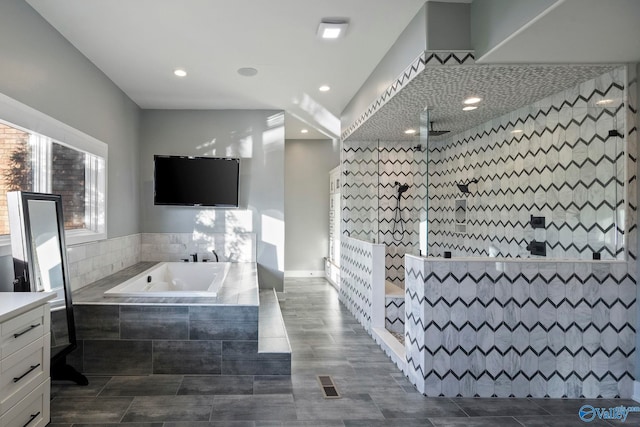 bathroom featuring a bath, recessed lighting, visible vents, and walk in shower