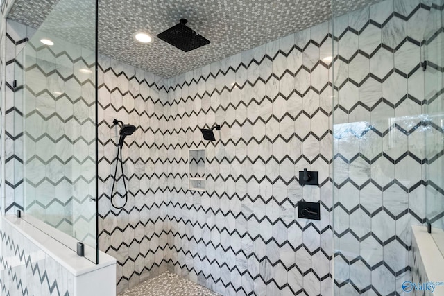 full bath featuring tiled shower