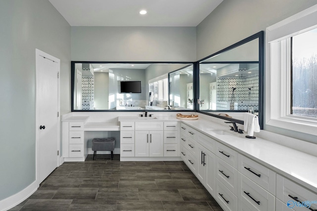 bathroom with recessed lighting, a stall shower, and vanity