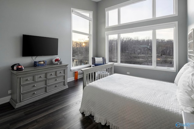 bedroom with baseboards and dark wood-style flooring