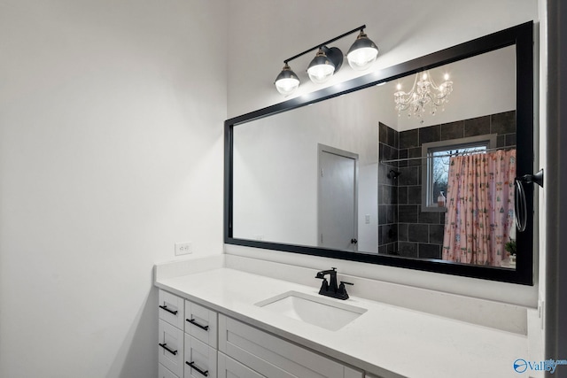 full bathroom featuring tiled shower, an inviting chandelier, and vanity