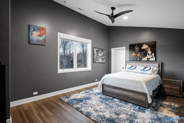 bedroom with visible vents, lofted ceiling, a ceiling fan, wood finished floors, and baseboards