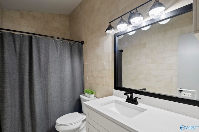 full bathroom with a shower with curtain, toilet, tile walls, and vanity