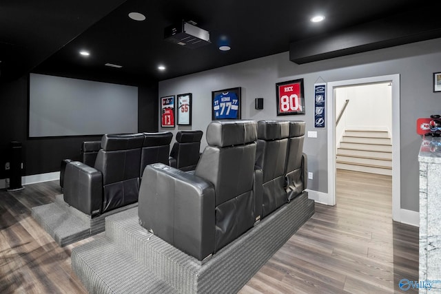 home theater room with recessed lighting, baseboards, and wood finished floors