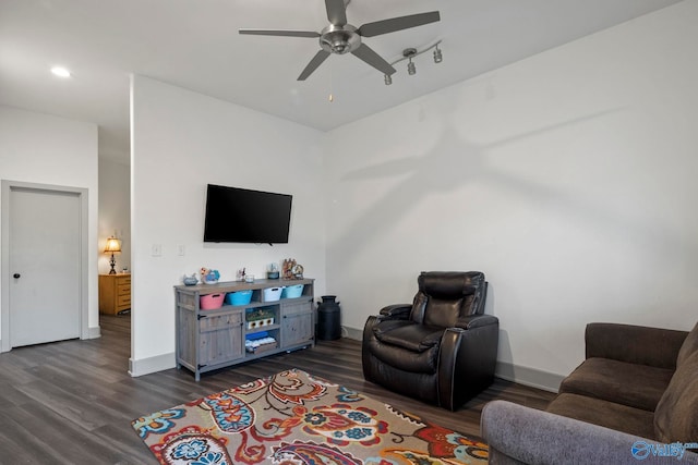 living area featuring dark wood-style floors, baseboards, and a ceiling fan