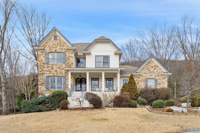 view of front of property featuring covered porch and a front yard