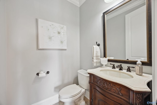 bathroom featuring crown molding, vanity, and toilet