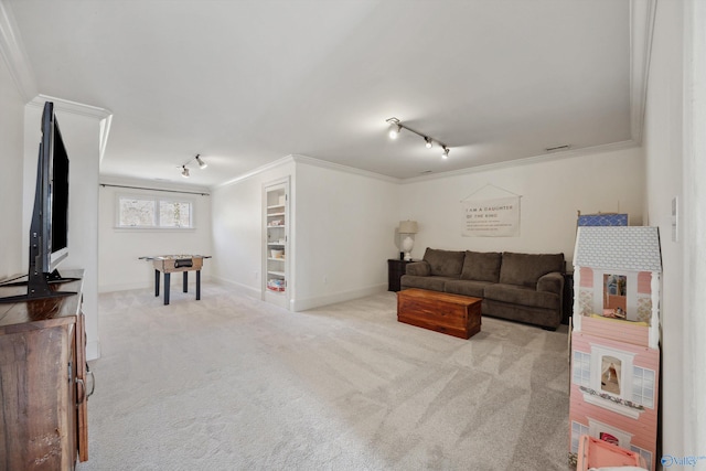 carpeted living room with crown molding and track lighting