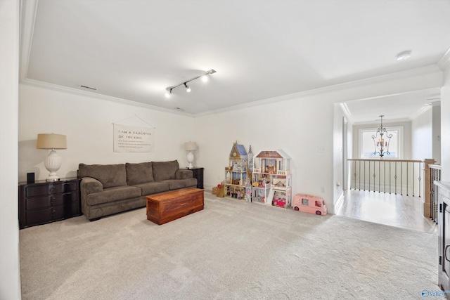 living room with crown molding, light colored carpet, and an inviting chandelier