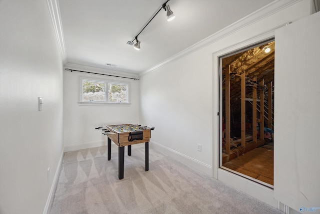 playroom with light carpet, crown molding, and rail lighting