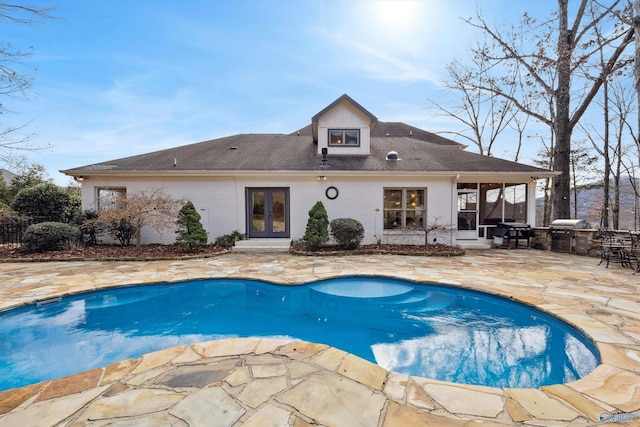 view of swimming pool featuring area for grilling and a patio area