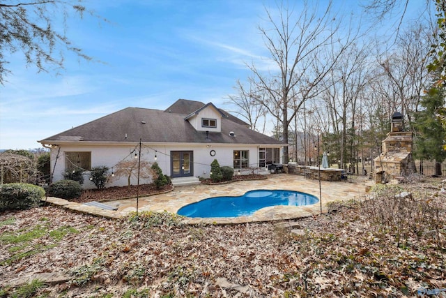 view of pool with a patio and a fireplace