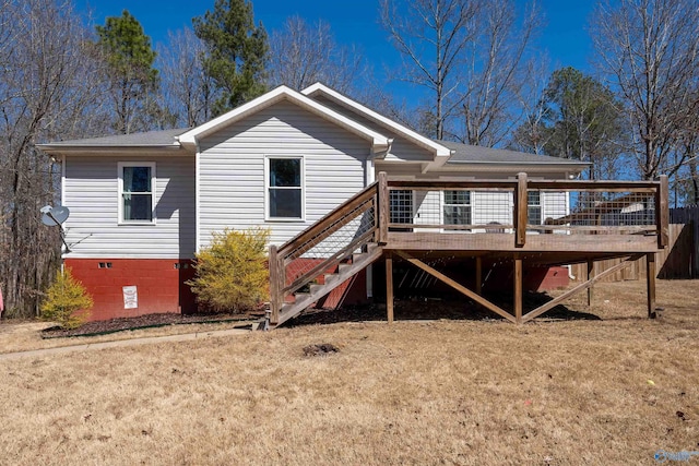 rear view of property featuring crawl space, stairway, a lawn, and a wooden deck