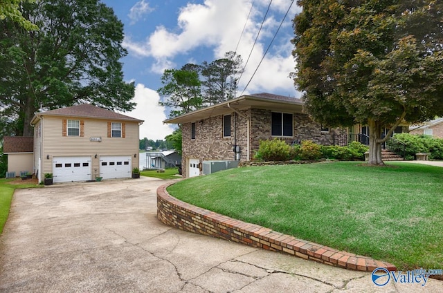 view of side of property with a garage, central AC, and a lawn