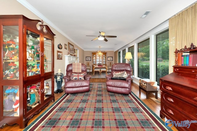 living room with crown molding, hardwood / wood-style flooring, and ceiling fan