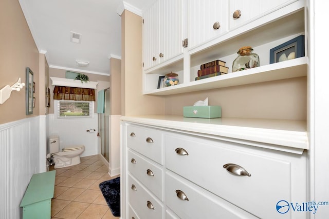 bathroom with an enclosed shower, vanity, ornamental molding, tile patterned floors, and toilet