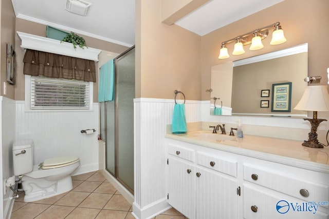 bathroom featuring tile patterned flooring, vanity, toilet, and walk in shower