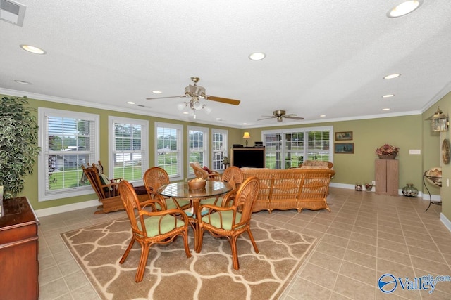 tiled dining space with crown molding and a textured ceiling